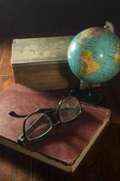 Globe with book and eyeglasses.