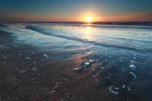 sunset over North sea sand beach photo