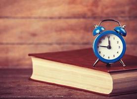 Alarm clock and book photo