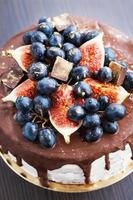 Chocolate icing cake, decorated with fresh fruit photo