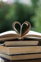 stack of books with heart shape photo