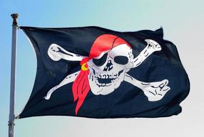 Pirate flag fluttering ominously on the wind photo