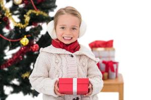 Festive little girl holding a gift photo