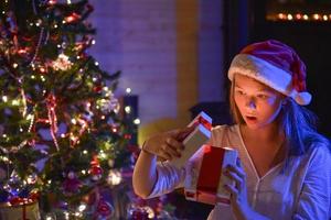 Christmastime, an expressive young girl opening her gift-box photo