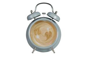 Hot coffee with frothy foam inside a blue alarm clock  photo