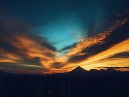 Silhouette of a mountain during sunset. photo