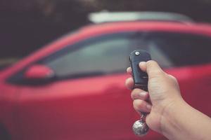 Man pushing button on remote control car key photo