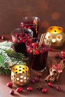 glass of mulled wine with cranberry and spices, winter drink