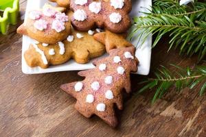 Colorful Christmas gingerbread cookies on wooden background photo