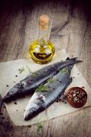 Raw seabass fish on the wooden board photo