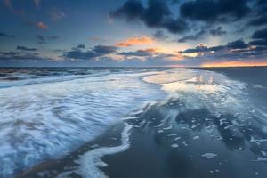 sunrise over North sea coast during low tide photo