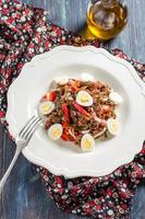 salad with sea cabbage, red rice, peppers and quail eggs photo