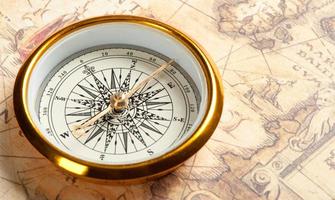 Old compass on ancient map photo