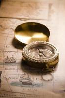 Old compass on ancient map photo