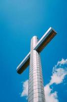 Steel cross on a mountain top photo