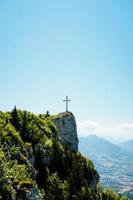 Cross on top of a mountain photo