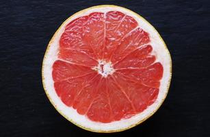 Pink grapefruit on slate background photo