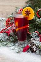 mulled wine with decorated christmas tree photo