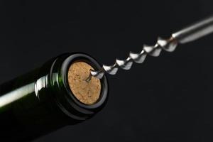 red wine bottle and corkscrew photo