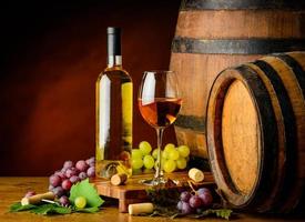 white wine and grapes with barrel photo