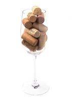 Wine glass filled with wine corks