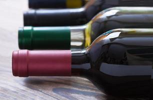 Wine bottles on wooden background photo