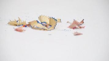 Pencil shavings drop on the white desk isolated video