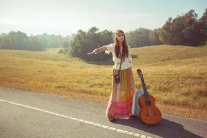 Hippie girl hitchhiking photo