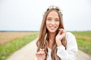 smiling young hippie woman on cereal field photo