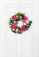 Floral wreath on white door photo