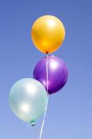 colorful balloons isolated on blue photo