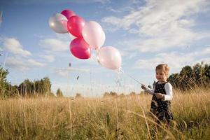 Little girl with balloons photo