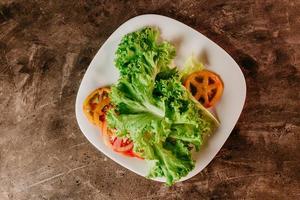 Lettuce and tomatoes on a plate photo