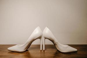 High heel shoes on wooden table photo