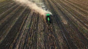 Aerial view of tractor plowing the soil video
