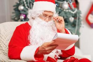 Santa Claus sitting in the arm chair photo