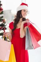 Brunette in red dress holding shopping bags