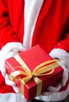 Santa Claus Showing a Christmas Gift Box photo