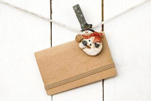 Christmas snowman clothespins holding greeting card photo