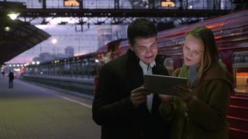 People Using Tablet PC at Railroad Station