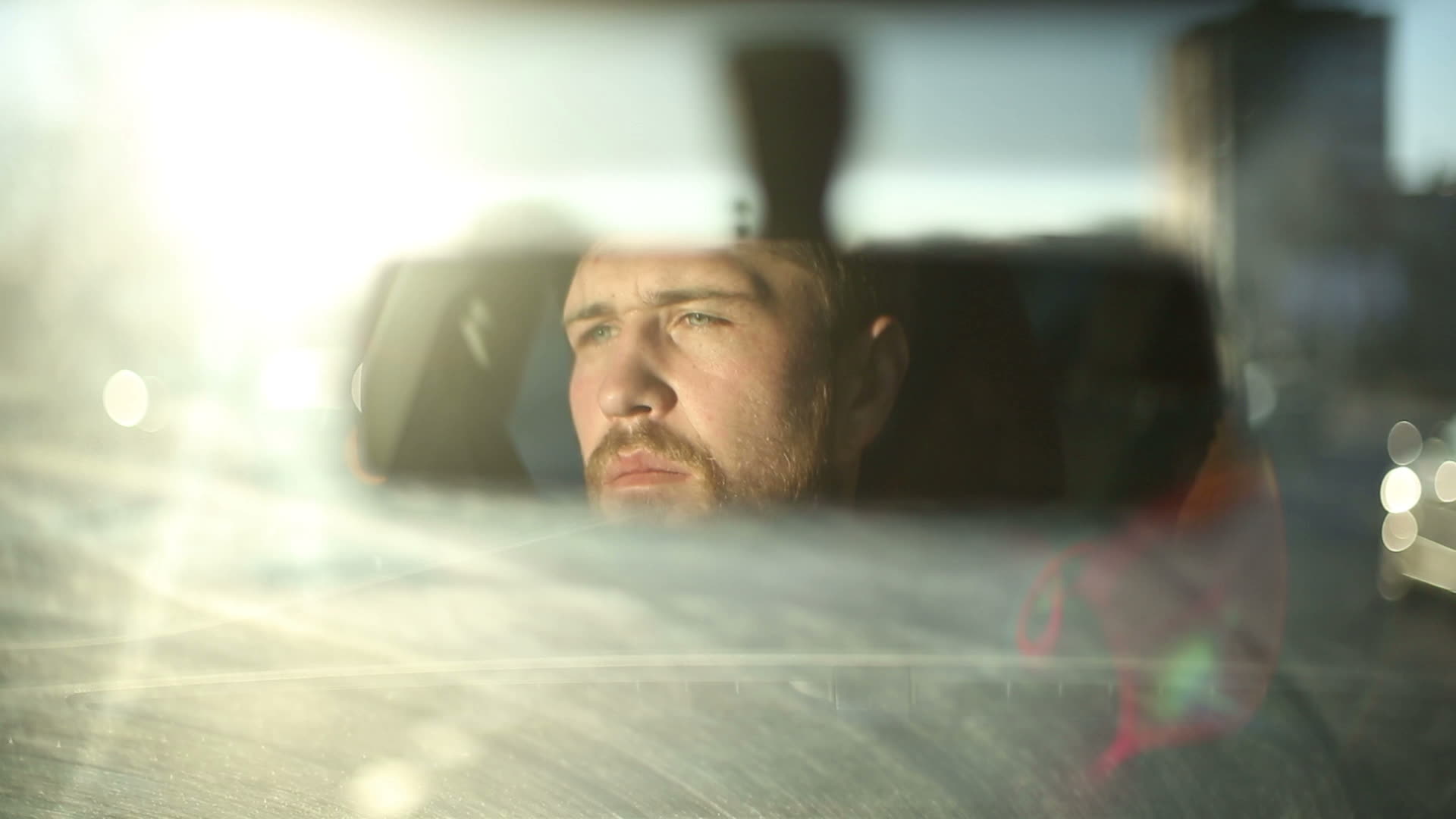 Reflection male face in the rearview mirror of the car 1395734 Stock