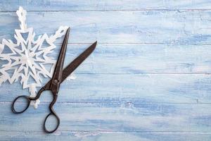 Vintage scissors and paper snowflake at left side photo