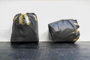 Two black garbage bags photo