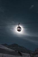 Cable ride in front of the moon photo