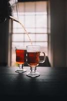Pouring tea into tea cup photo