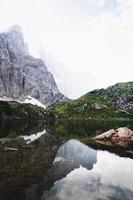 Calm body of water near mountain photo