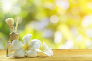 Perfume bottle with white flowers photo