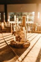 Three clear glass bottles on brown table photo