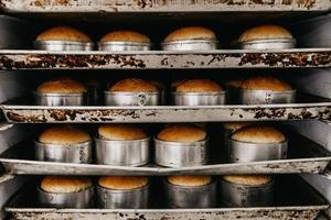 Rows of baked bread on kitchen racks photo