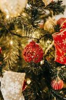 Red baubles on Christmas tree photo